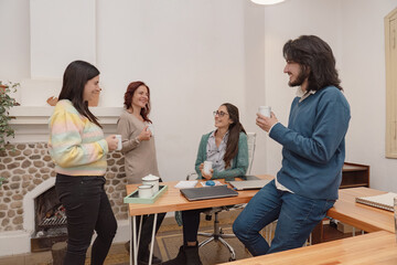 Business team having a friendly coffee in the office.
