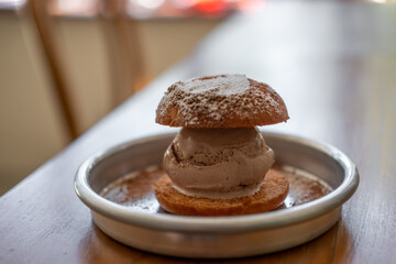 Chocolate ice cream with fried bun served on plate