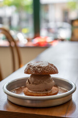Chocolate ice cream with fried bun served on plate