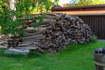 Old house with beautiful garden, and pile of firewood.