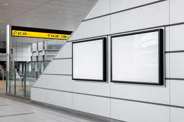 Two blank billboard posters down an escalator in an empty train station in Tokyo. Ideal for...