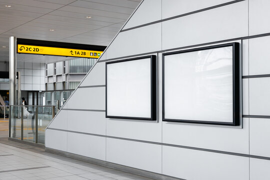 Two blank billboard posters down an escalator in an empty train station in Tokyo. Ideal for advertising and mockup
