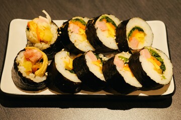 Kimbap is similar to Japanese sushi, but it has a few differences, such as the use of sesame oil in the rice and the inclusion of a wider variety of vegetables and meats.
