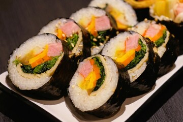 Kimbap is similar to Japanese sushi, but it has a few differences, such as the use of sesame oil in the rice and the inclusion of a wider variety of vegetables and meats.