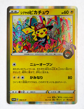 Hamburg, Germany - 05182024: photo of the japanese holo Shibuyas Pikachu S-P 2 Sword and Shield Promo trading card on white paper background.