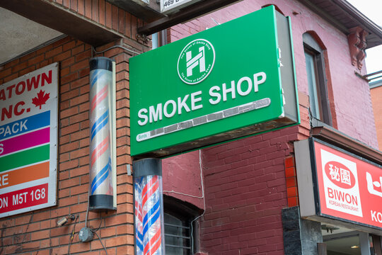 signs near 473 Dundas Street West in Toronto, Canada (Smoke shop, barber pole, Biwon Korean Restaurant)