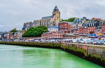 Fototapeta premium Impressive view of Le Treport at low tide, a traditional fishing village with colorful houses in Normandy, Northern France 