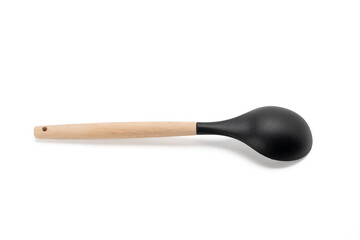 Black spoon with wooden handle. Spoon sitting on a white background