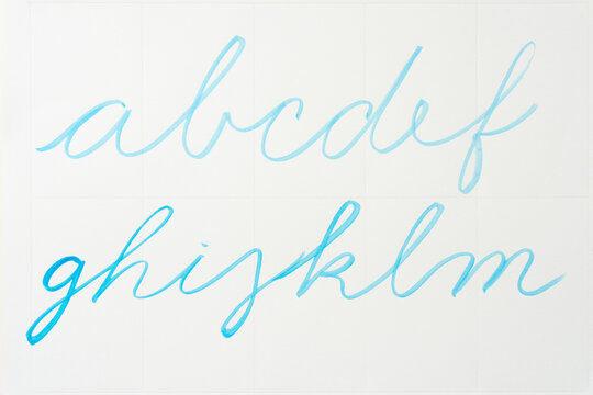 cursive alphabet in blue