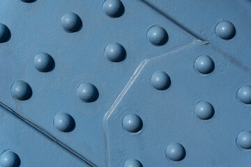 Photo background texture, metal surface with rivets, blue color on the bridge.