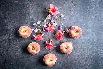 Five fresh peaches with flowers in summer