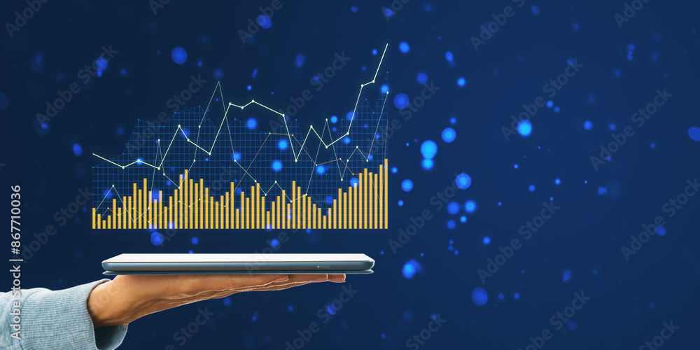 Poster a hand holding a tablet displaying a holographic graph, with gold bars and lines on a dark blue back