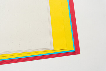 stack of various paper corners arranged in staggered form on blank paper