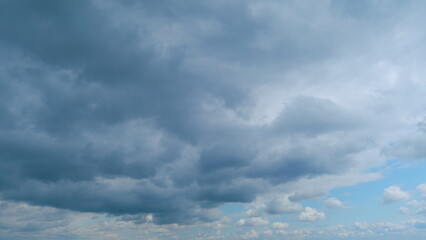 Clouds moving backlit by the day sun. Beautiful nature storm clouds. Time lapse.