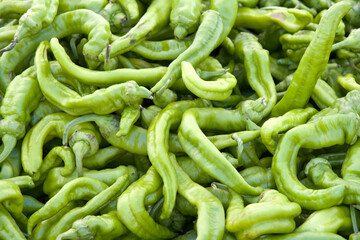 Close up on pile of fresh ripe sweet italian peppers for sale at farmers market. View from above.
