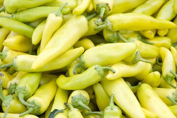 Close up on a pile of Hungarian Yellow Wax Peppers sale at farmers market.. View from above.