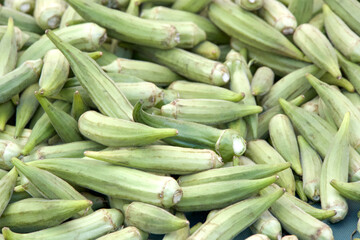 Close up on pile of fresh raw Okra sale at farmers market. View from above.