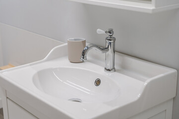 white sink and faucet in bright modern bathroom