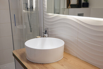 white sink and faucet in bright modern bathroom