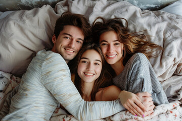 Ethical non-monogamy polyamory relationship concept. Three friends people lovers embracing lying together in bed. Friendship, happiness togetherness