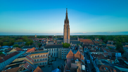 Enchanting aerial view of Bruges' historic old town captured by a drone at night! The illuminated medieval architecture, winding canals, and charming cobblestone streets create a magical and captivati