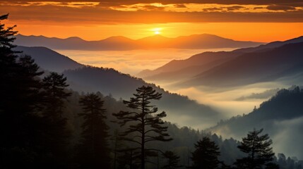 Obraz premium A stunning sunset over a range of hilly mountains, with dense layers of fog creating a serene and awe-inspiring view of nature's beauty.