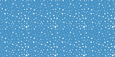 Light blue background and randomly placed flakes. Vector seamless pattern of white dots of different sizes.