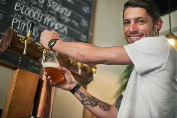 Portrait, happy man or bartender with beer on tap, alcohol or beverage drink at pub. Face, barman...
