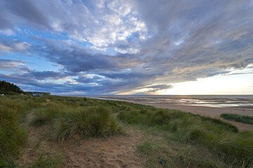 Low clouds over a Old Hunstanton beach at sunset