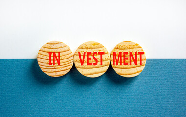 Investment symbol. Concept word Investment on beautiful wooden circles. Beautiful blue white background. Business investment concept. Copy space.