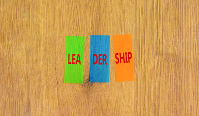 Leadership symbol. Concept word Leadership on beautiful colored paper. Beautiful wooden background....