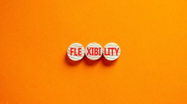 Flexibility symbol. Concept word Flexibility on beautiful wooden circles. Beautiful orange background. Business flexibility concept. Copy space.