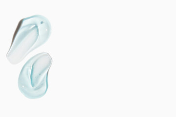 Smears of cosmetic texture of blue gel on a light background