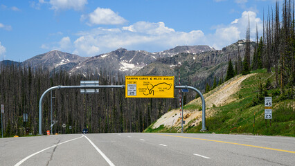 Road sign across US Highway 160 on west descent from Wolf Creek Pass Colorado towards Pagosa Springs