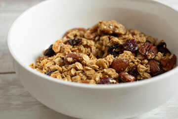 A closeup view of a bowl of granola cereal.