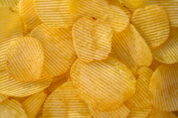 Crispy fresh potato chips, snacks background. Top view, flat lay. Banner
