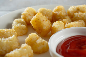 A closeup view of a plate of tater tots.