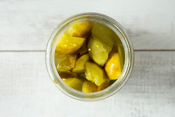 A top down view of a jar of pickles.