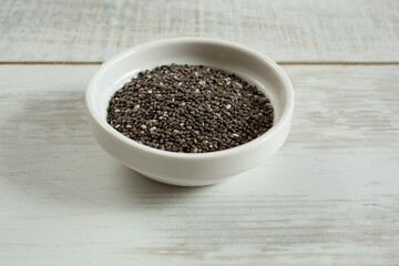 A view of a condiment cup of chia seeds.
