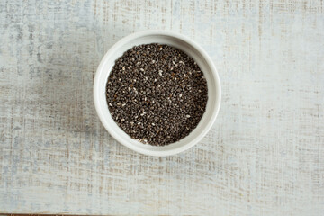 A top down view of a condiment cup of chia seeds.