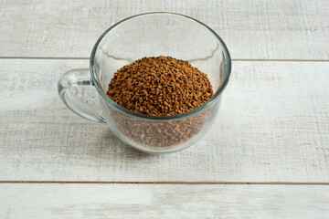 A view of a glass mug of instant coffee.