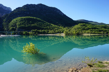 mirror reflection  of the mountains in ste croix lake, southern alps, france