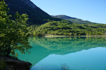 mirror reflection  of the mountains in ste croix lake, southern alps, france
