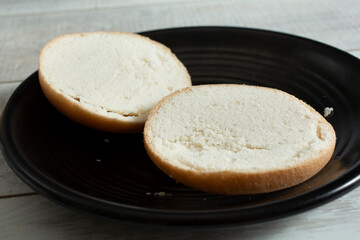 A view of a plate of a sliced open gluten-free bun.