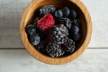 A top down view of a small bowl of frost berries.