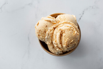 A top down view of scoops of pumpkin flavored ice cream.