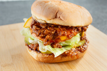 A view of a chili cheeseburger.
