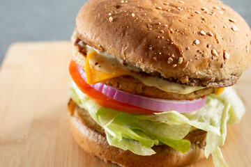 A closeup view of a turkey cheeseburger.