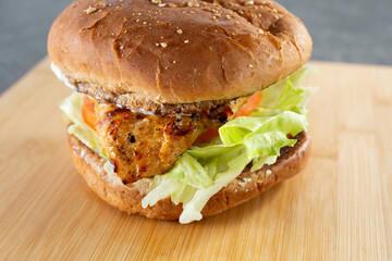 A closeup view of a charbroiled chicken sandwich.