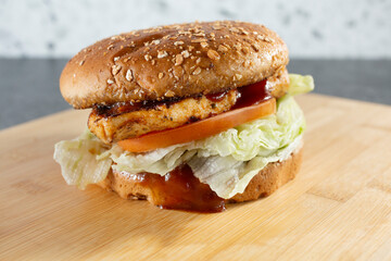 A closeup view of a BBQ chicken sandwich.